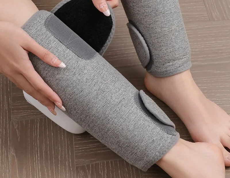 Hands securing the adjustable overlapping AirCalm wrap around a calf with the hook-and-loop closure