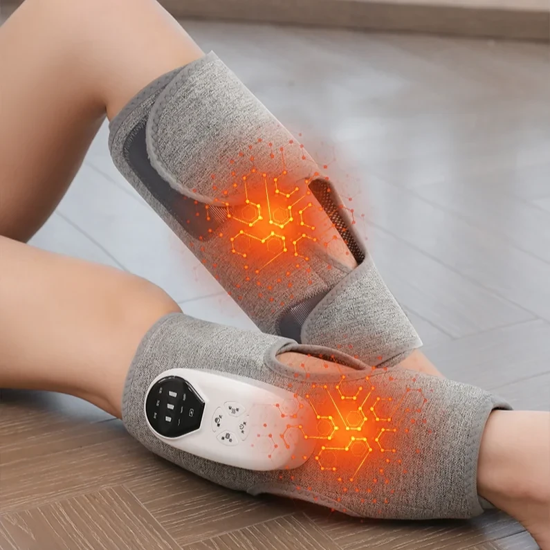 A person wearing gray AirCalm wraps on both calves, with the warming mode visualized in orange and the built-in white controller on the wrap